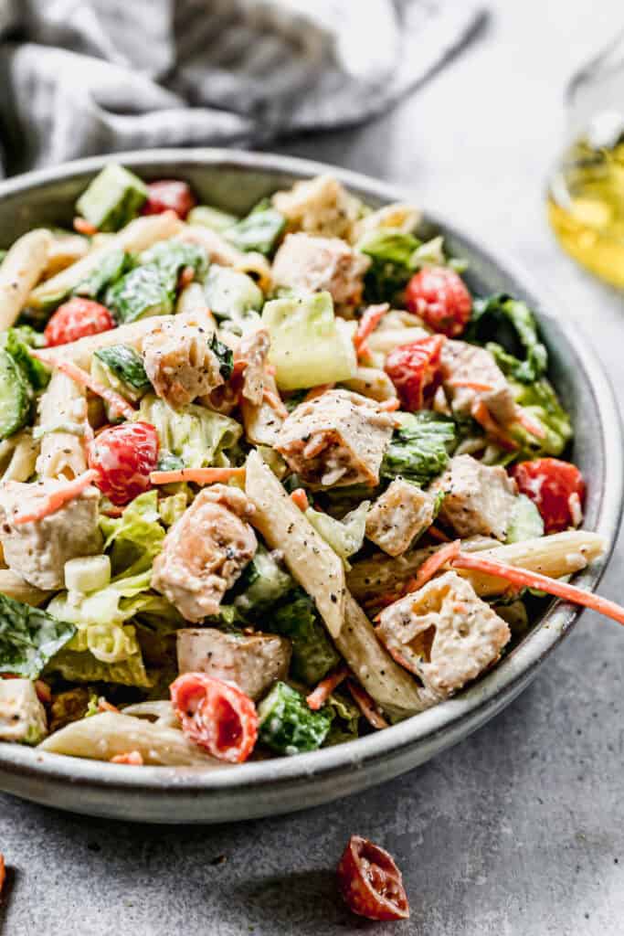 This high protein chicken caesar pasta salad recipe has everything you love about caesar salad with pasta to make it a hearty, fresh, and light meal perfect for summer!
