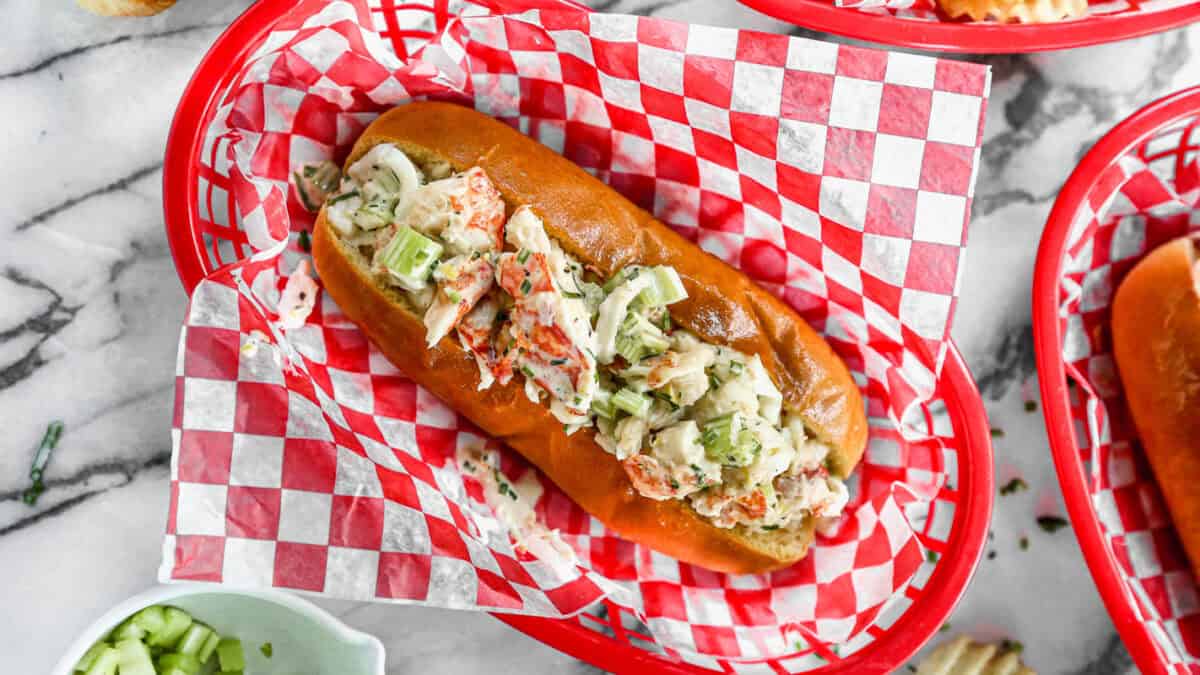 This easy Lobster Roll recipe has warm lobster tossed in a light sauce and served on a toasted bun. It's easier to make than you think and is worth every minute of prep!
