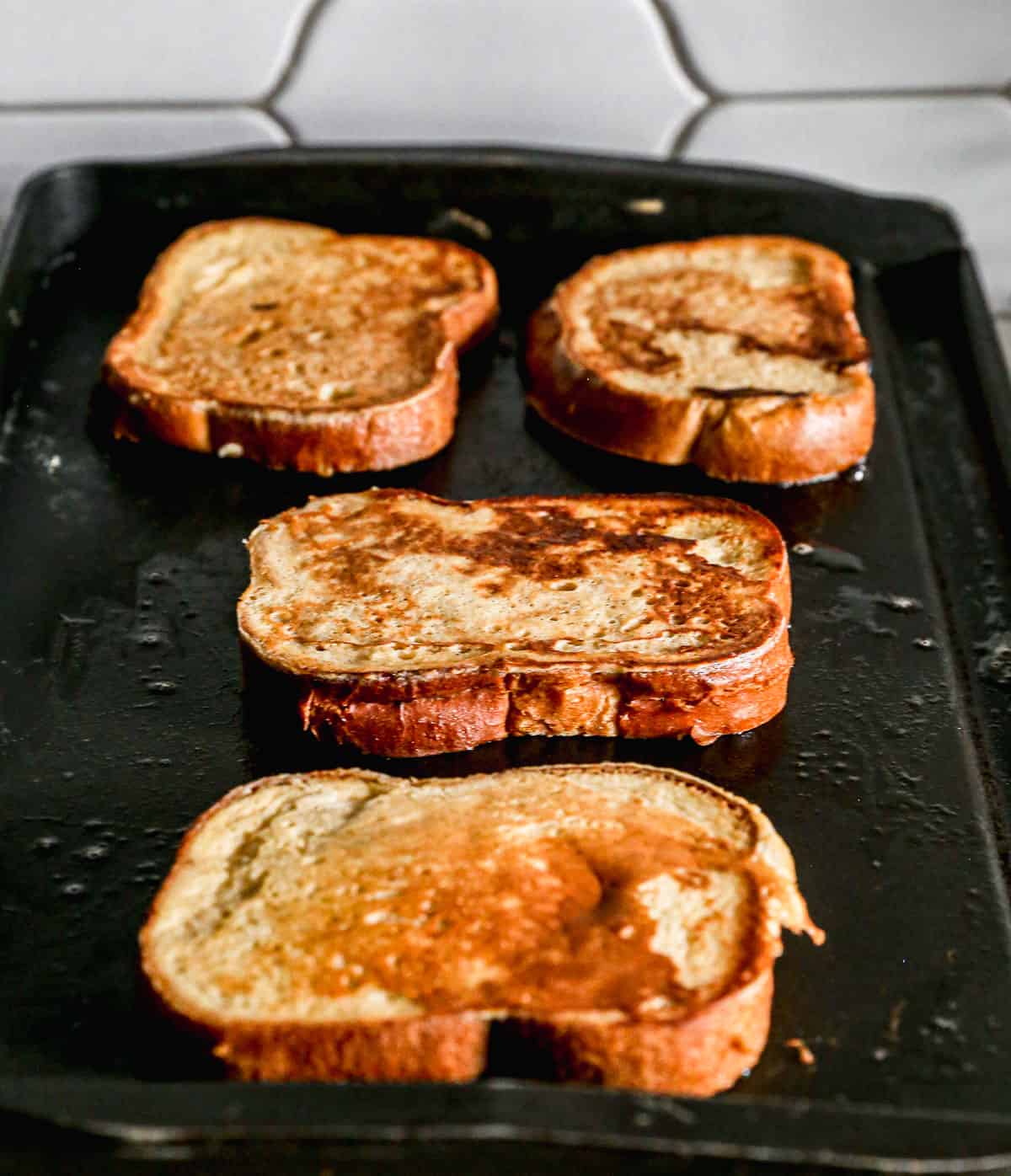 Golden homemade French Toast on a griddle. 