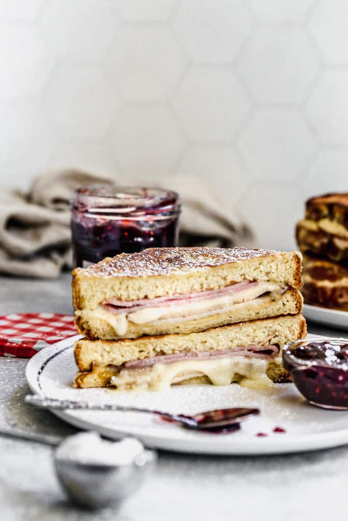 A homemade Monte Cristo Sandwich cut in half and stacked on a plate.
