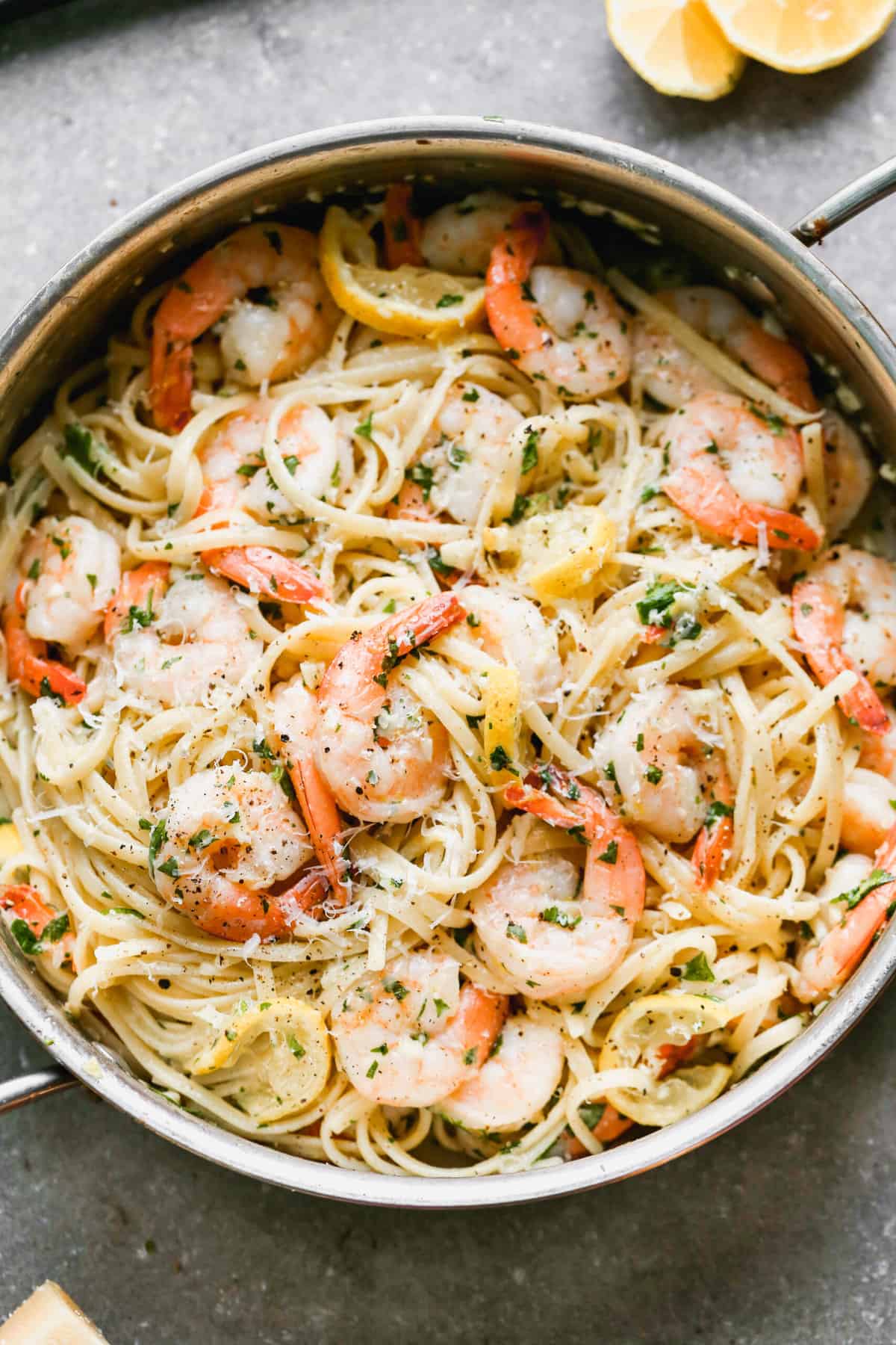A pan filled with Shrimp Linguine in a garlic lemon sauce and parmesan cheese.