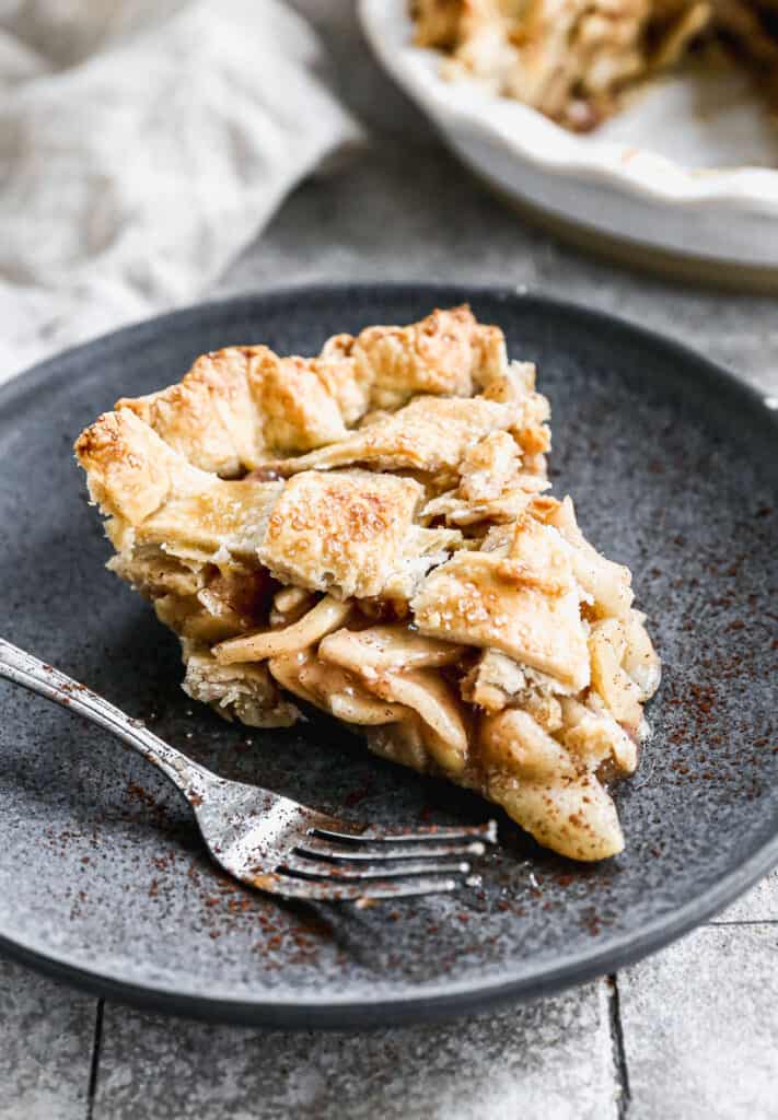 A slice of easy homemade Apple Pie on a plate with a fork.