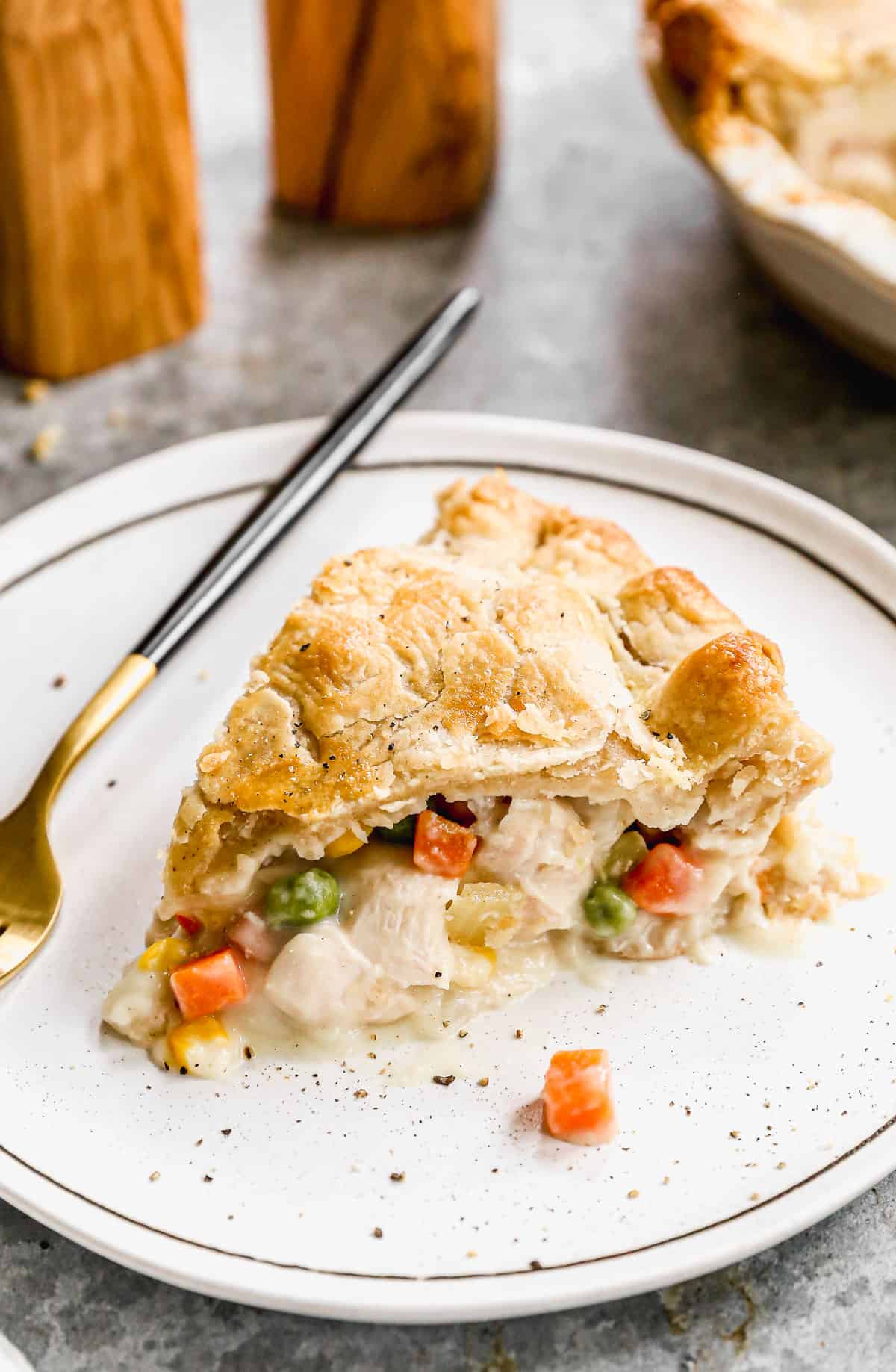 A slice of Chicken Pot Pie on a white plate.