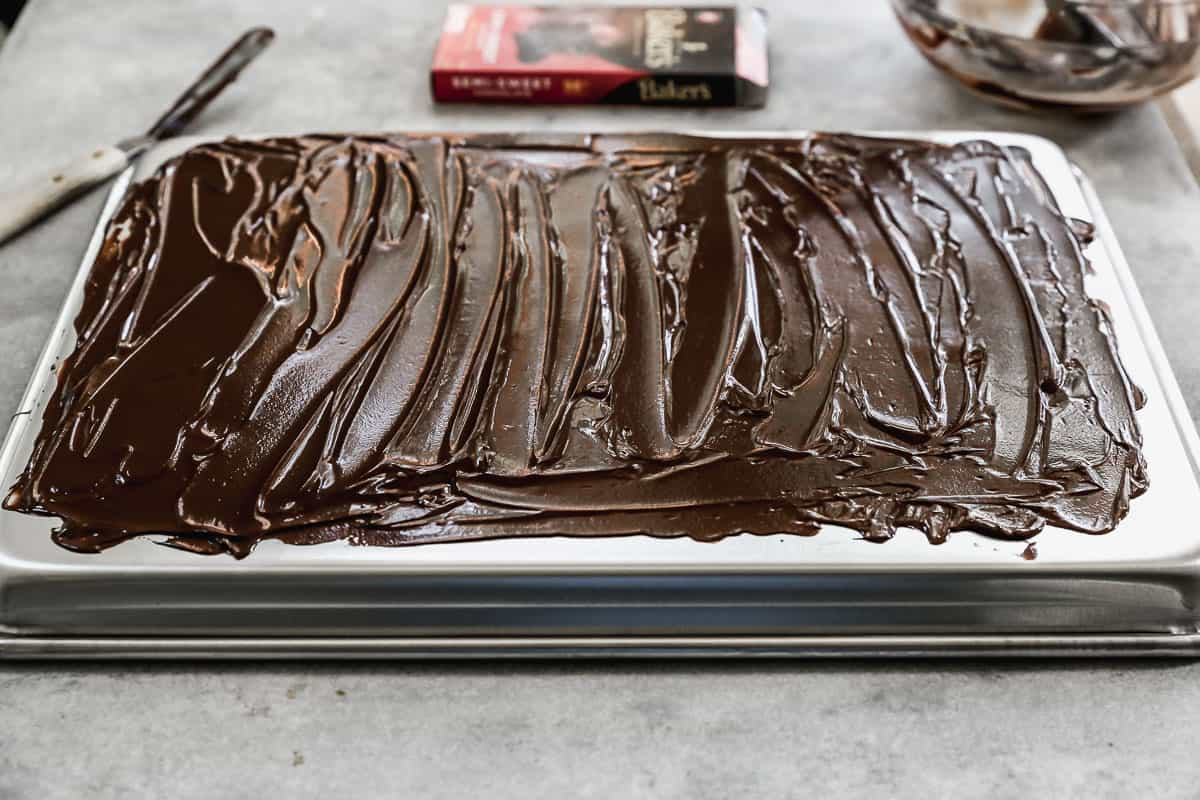 A baking sheet with a melted chocolate layer smoothed on the back of it.