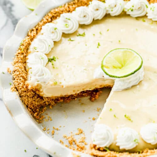 A Key Lime Pie with one piece taken out.