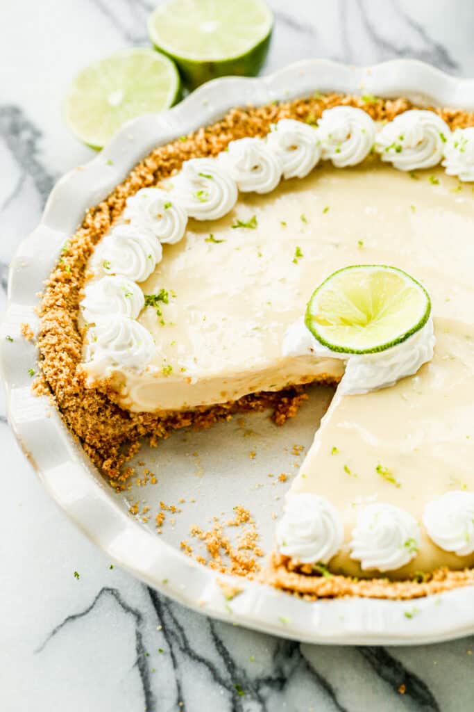 A Key Lime Pie with one piece taken out.