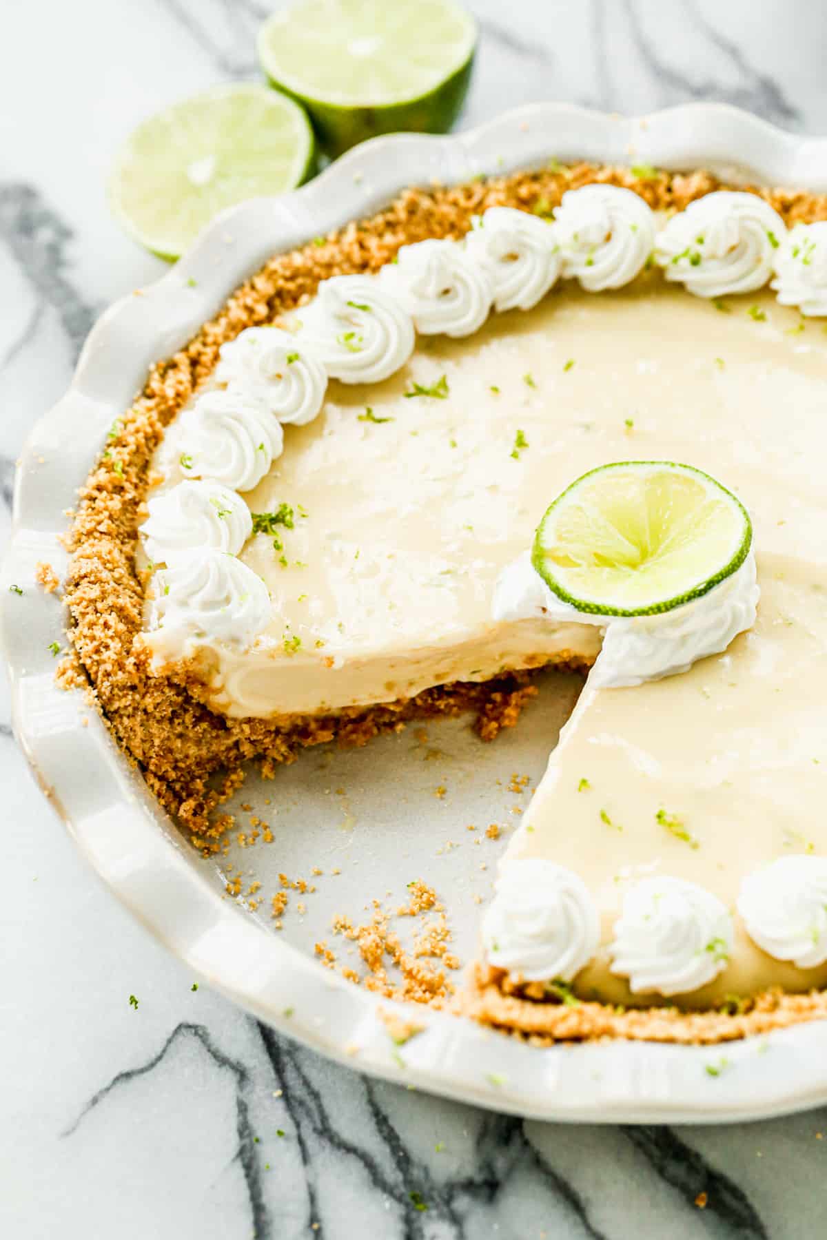 Homemade Key Lime Pie with one slice taken out.