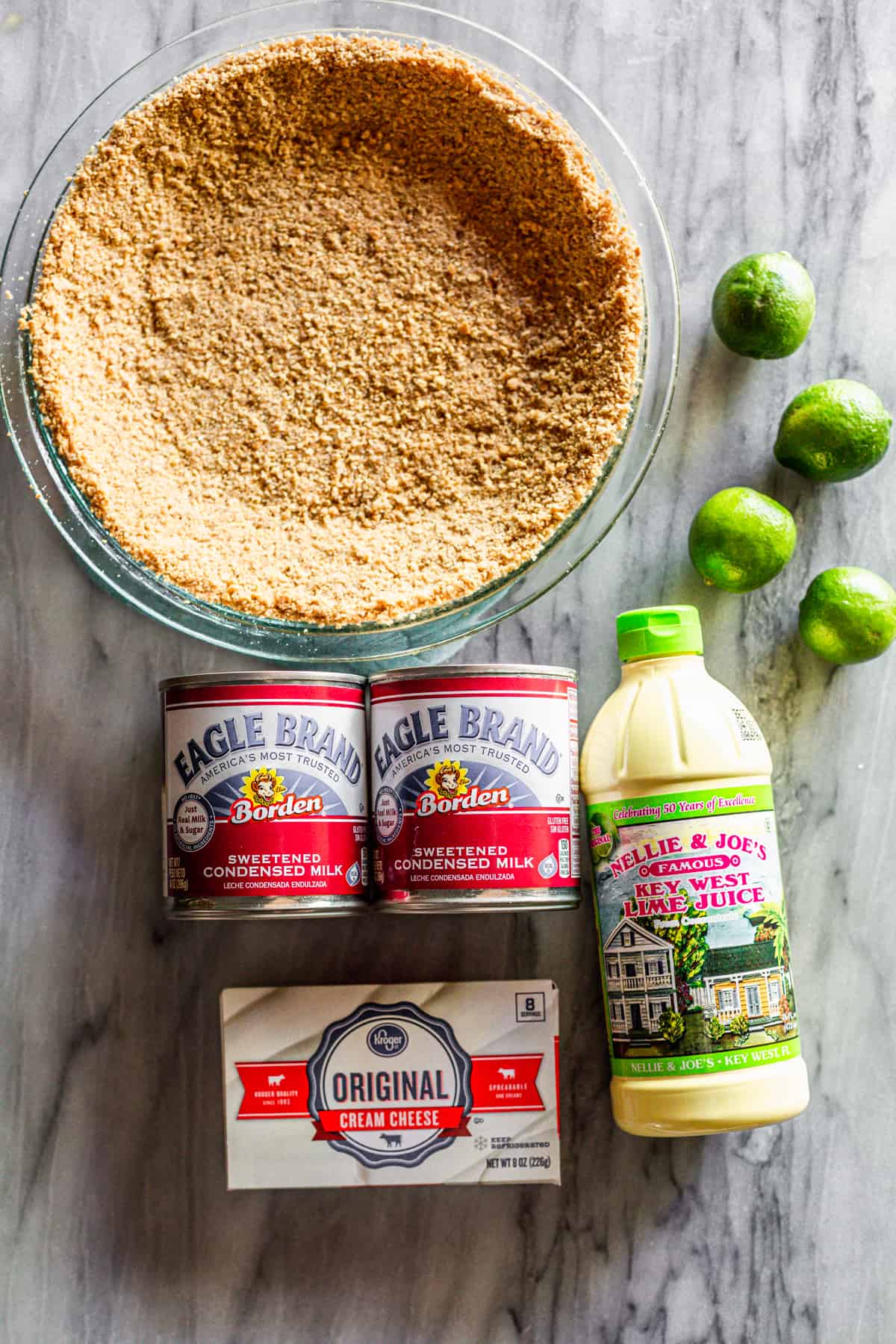 The ingredients needed to make the BEST Key Lime Pie recipe: Key Lime Juice, Graham Cracker Crust, Lime Zest, Sweetened Condensed Milk, and Cream Cheese.