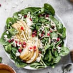 A Pear and Pomegranate Salad in a big white serving bowl, ready to enjoy.