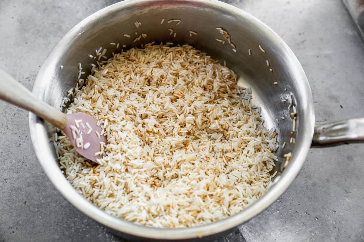 A pot with rice being toasted to make homemade Rice Pilaf.