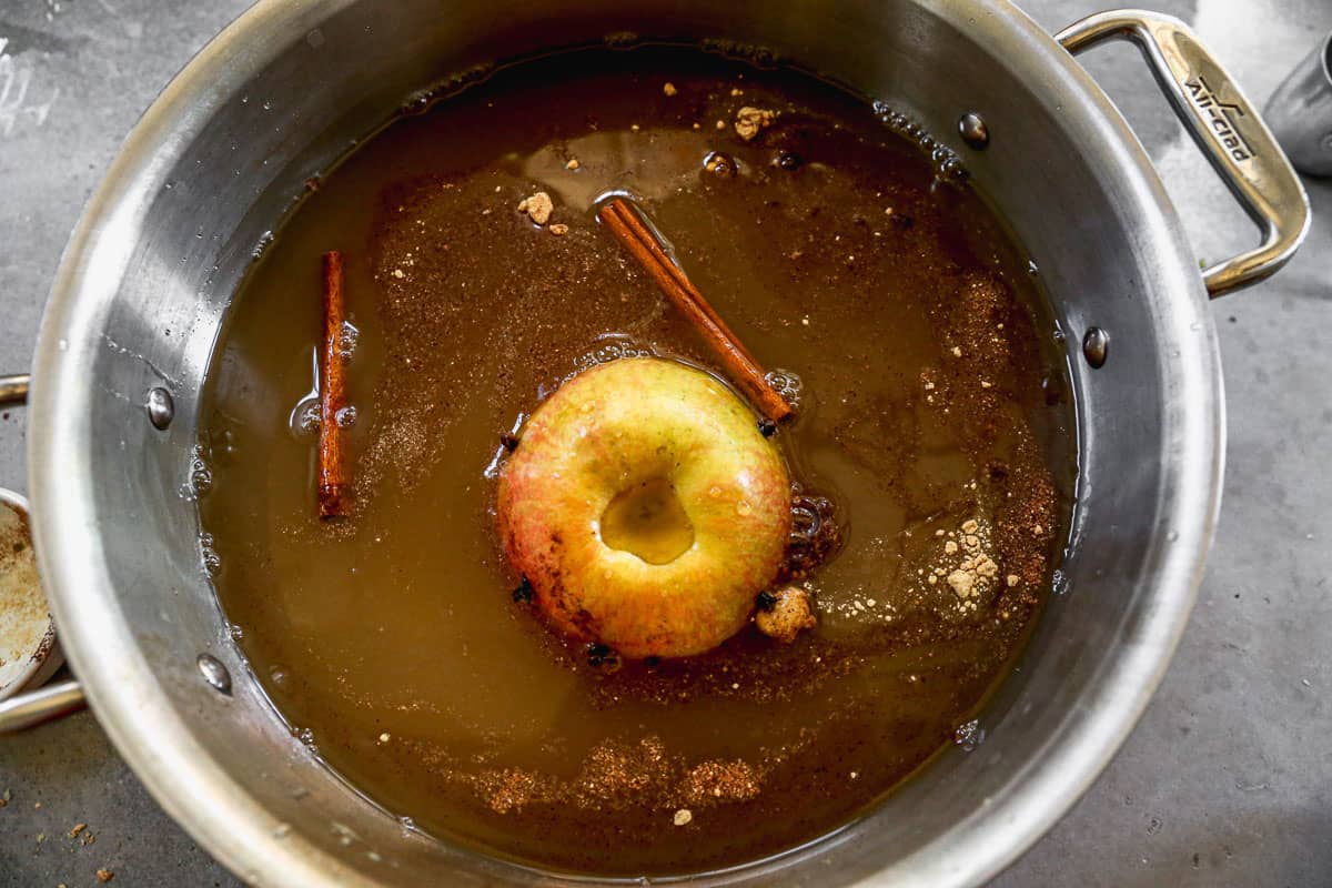 All the ingredients combined in a pot to make hot wassail.