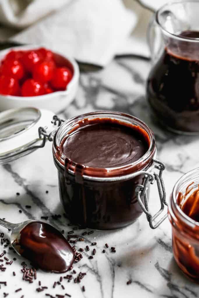 Smooth homemade hot fudge in a jar, ready to spoon over ice cream, brownies, or any dessert.