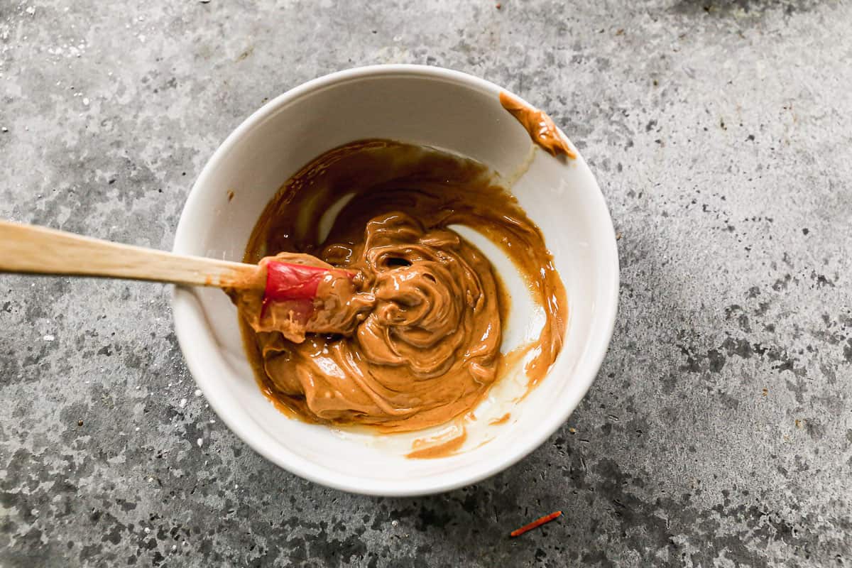Peanut butter and honey in a bowl for a peanut sauce.