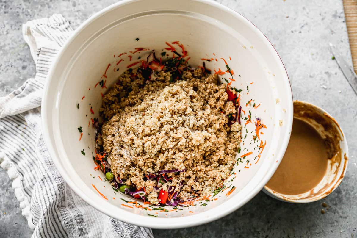 Quinoa poured on top of chopped vegetables to make an easy Thai Quinoa Salad.