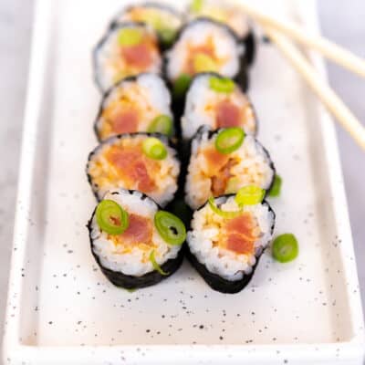 Spicy Tuna Rolls on a rectangle plate, ready to eat.
