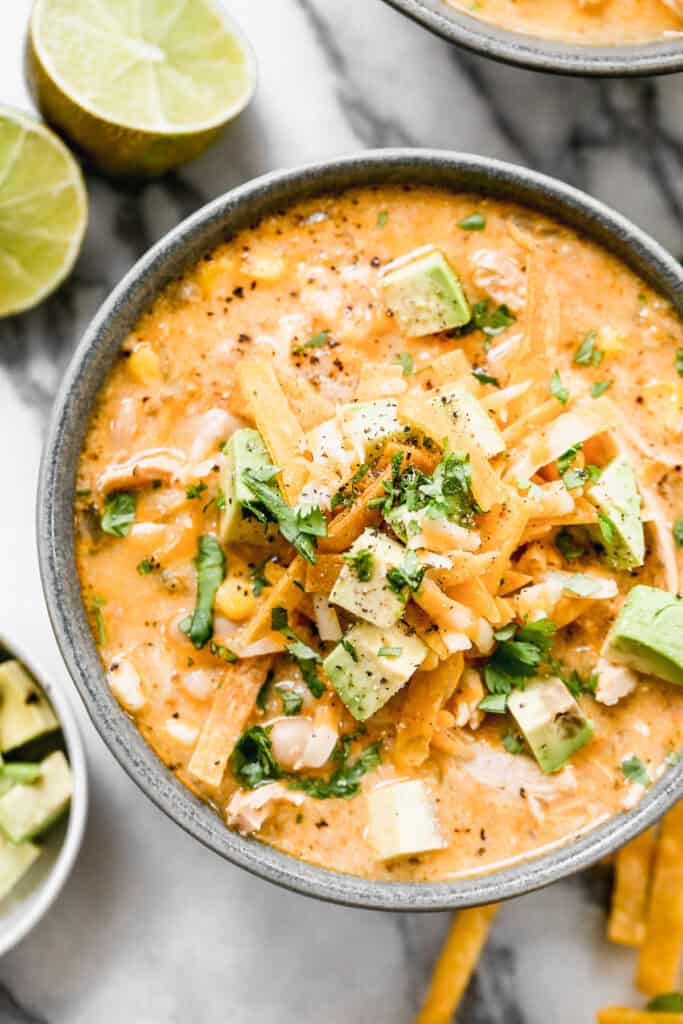 This Creamy White Chicken Chili recipe is healthy, high in protein, and flavorful. We get that creamy texture from blended beans so you can enjoy it and still feel great!