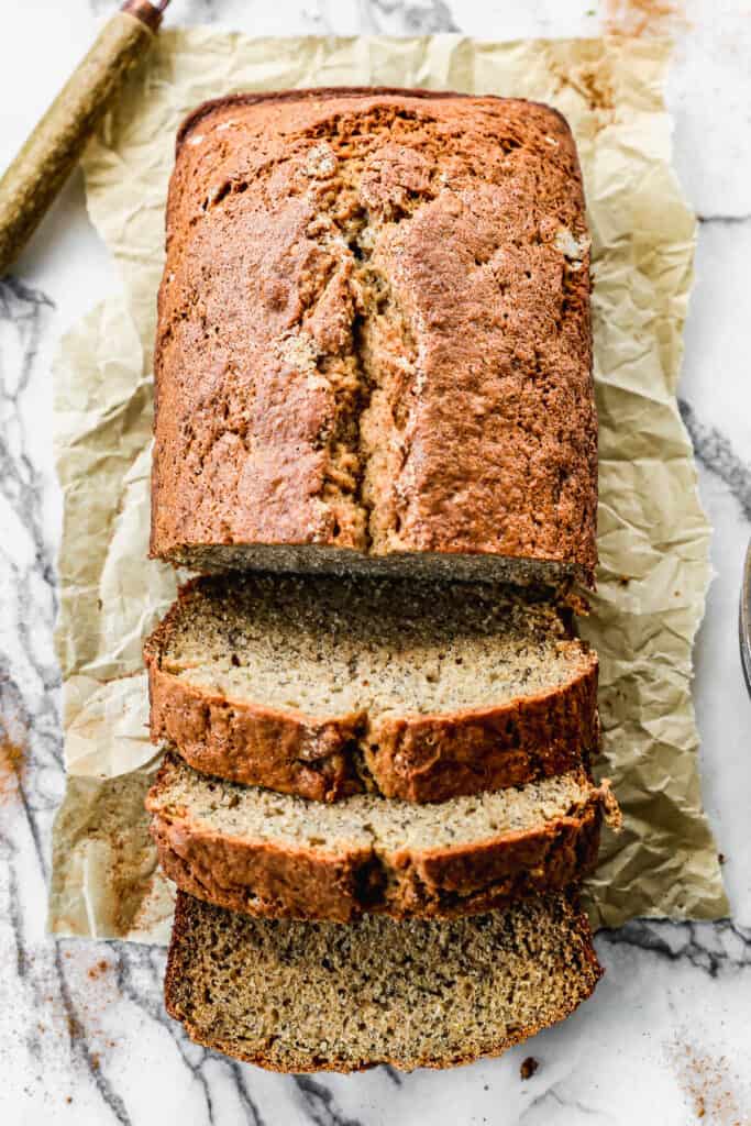 A loaf of our favorite Banana Bread, half of it sliced.