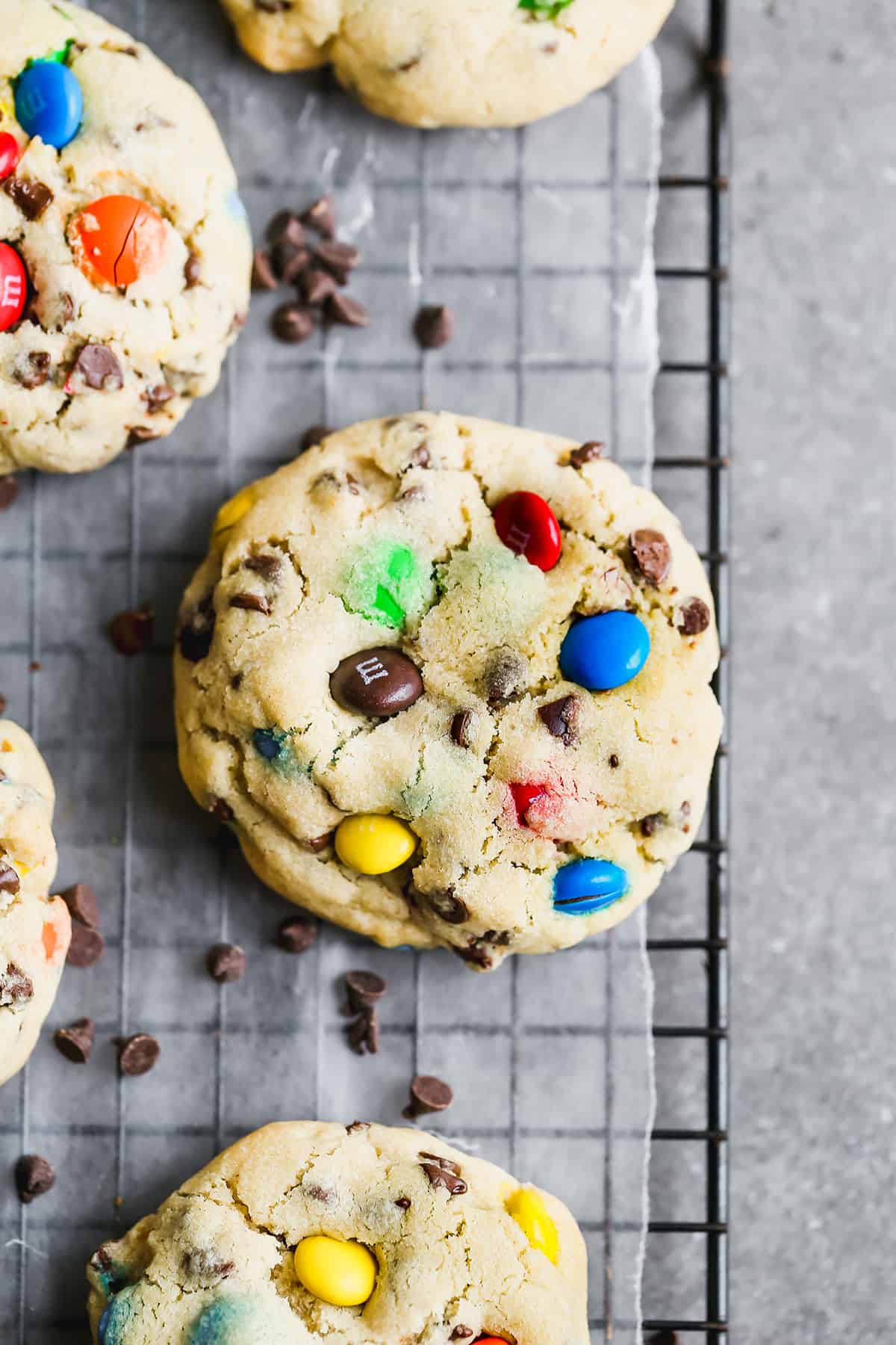 Large M&M cookies on a wore cooling rack. 