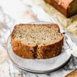 Two thick slices of the best banana bread stacked on a plate, ready to enjoy.