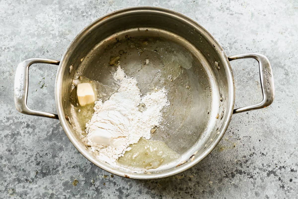 Butter and flour in a large pot to make a roux for Chicken Tetrazzini.