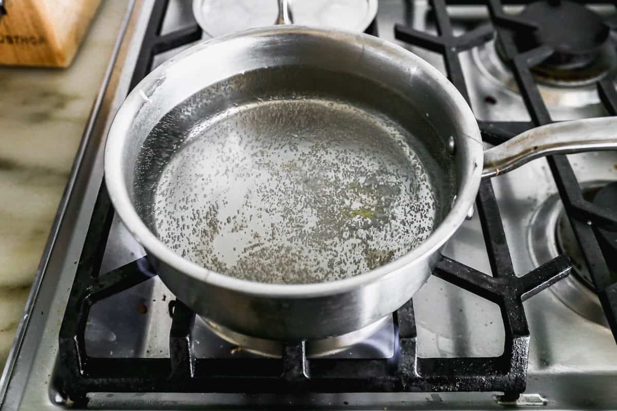 Water simmering in a pot on the stove to make an easy poached egg.