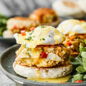 Crab Cake Benedict on a plate with homemade hollandaise sauce on top.