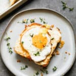 An easy Croque Madame sandwich on a plate topped with an egg.