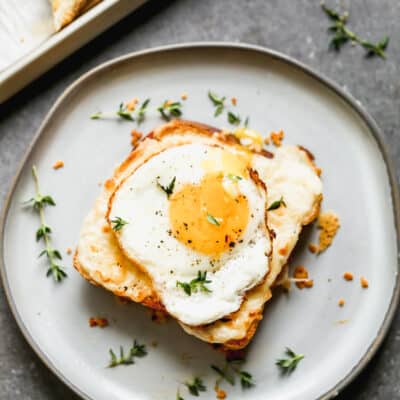 An easy Croque Madame sandwich on a plate topped with an egg.