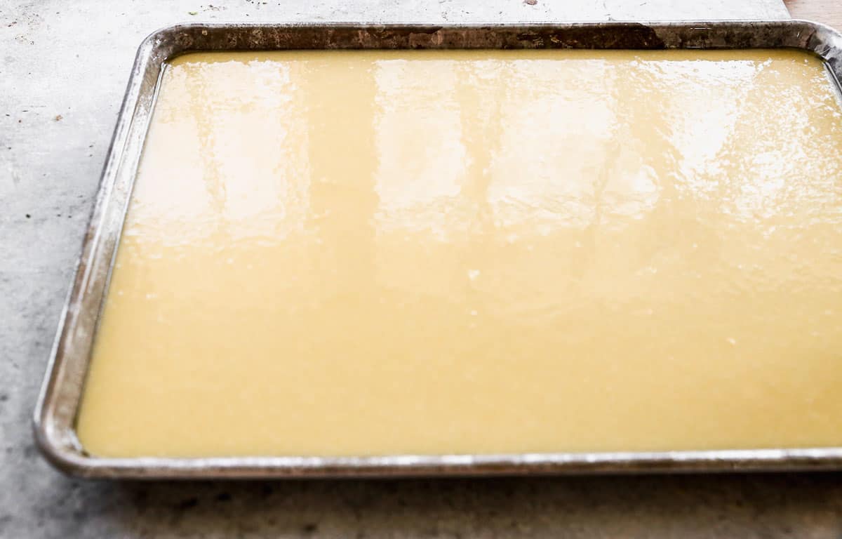White Texas Sheet Cake batter in a greased jelly roll pan, ready to bake.