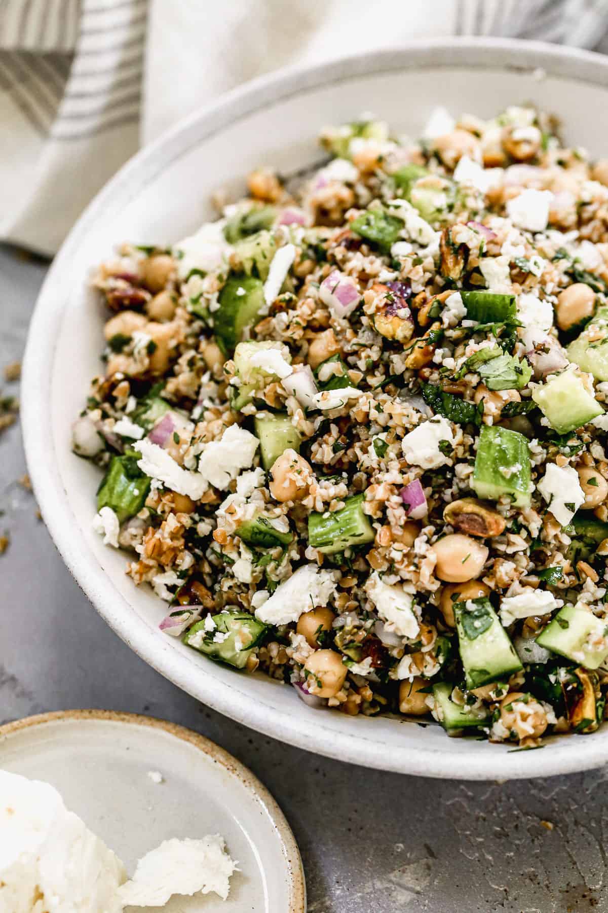 A large white serving bowl filled with an easy Bulgur Salad recipe.