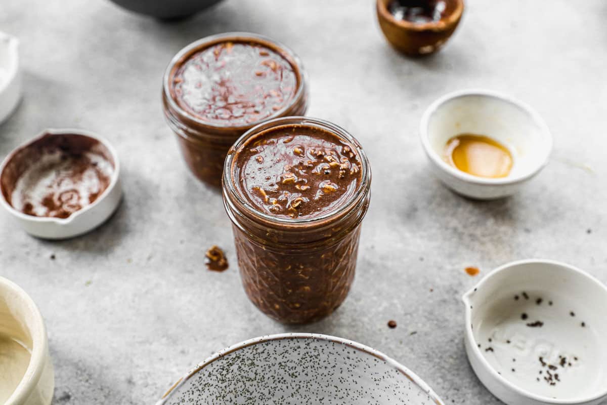The best chocolate overnight oats recipe in two mason jars ready to go in the fridge overnight.