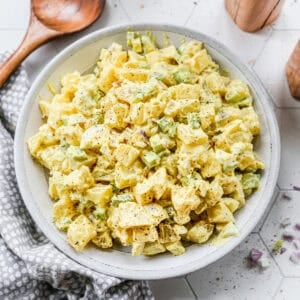 The best Potato Salad recipe with boiled eggs, celery, and chopped potatoes all covered in a creamy dressing.