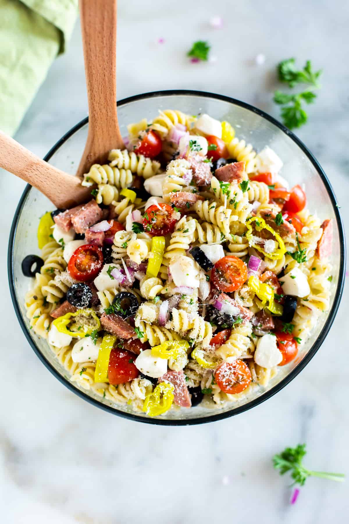 A glass serving bowl filled with the best Italian Pasta Salad recipe. 