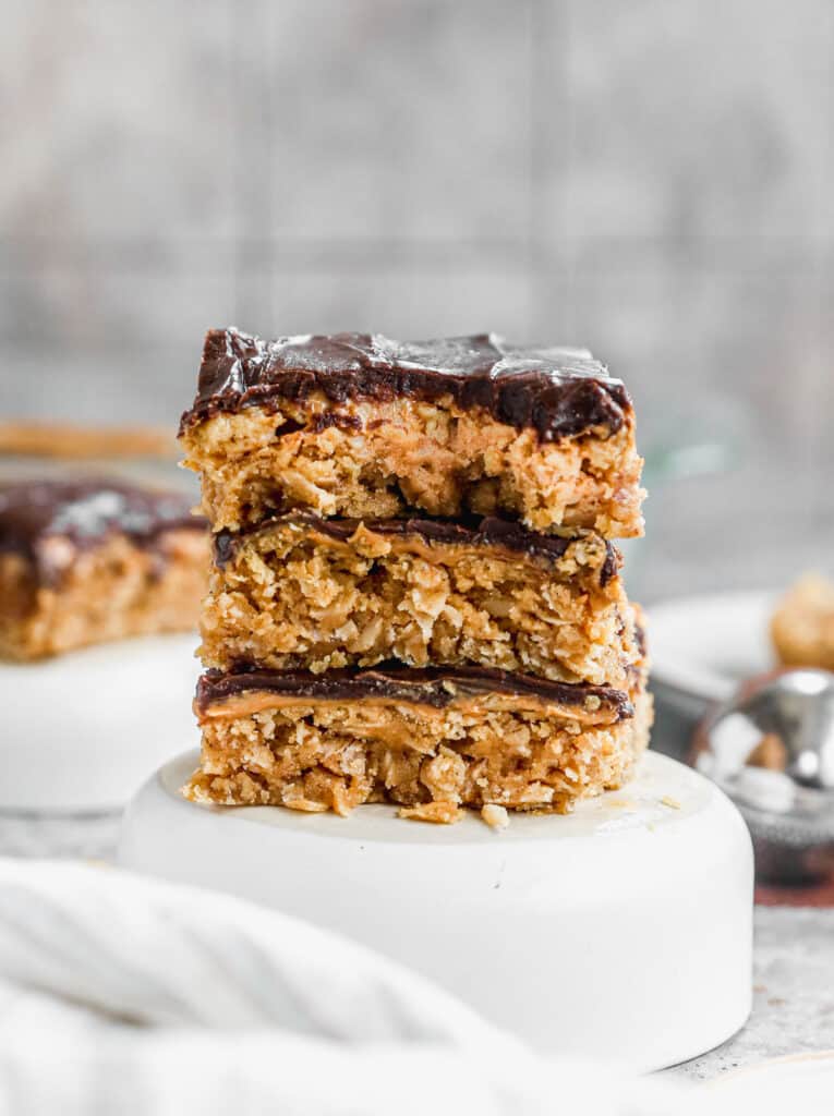 Three chewy peanut butter bars stacked on top of each other.