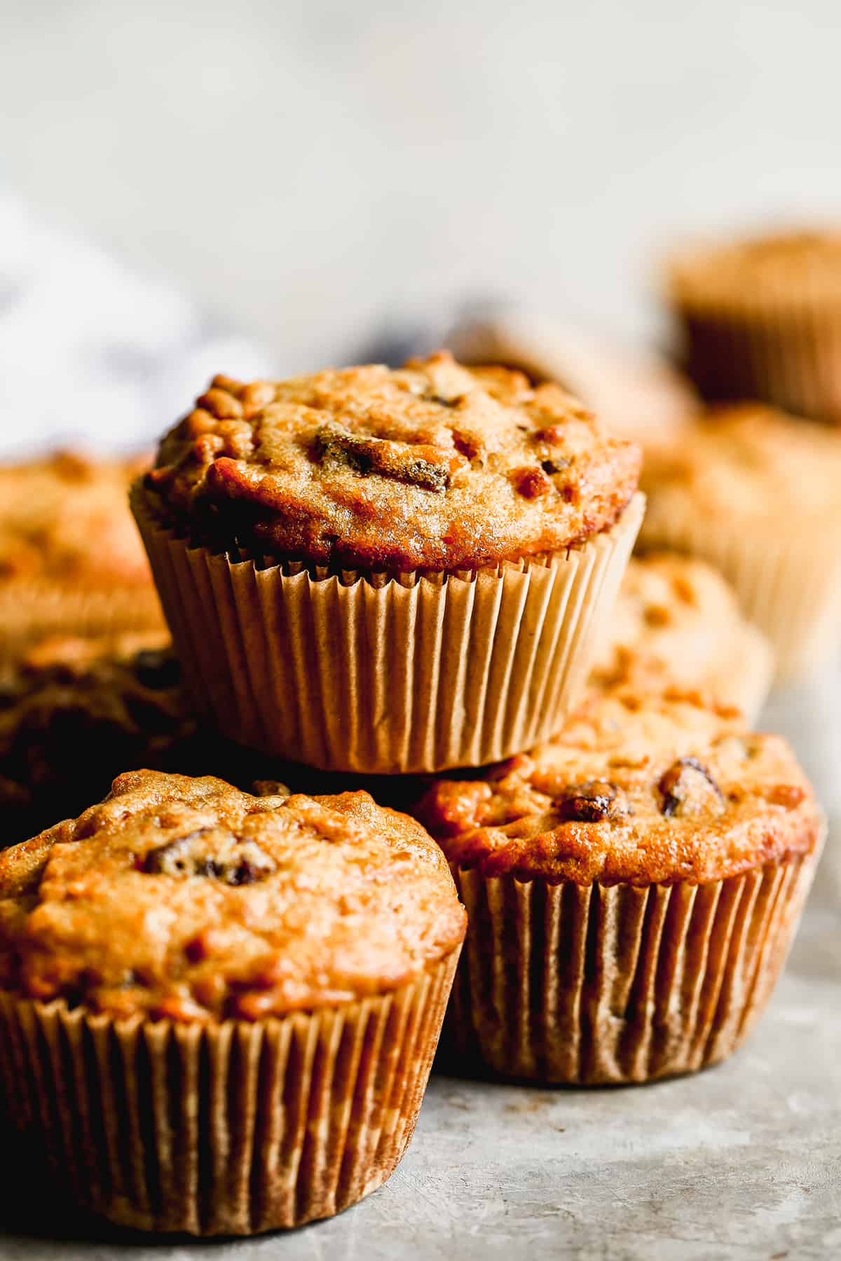 Bran Muffins baked in muffin liners and stacked on top of each other.