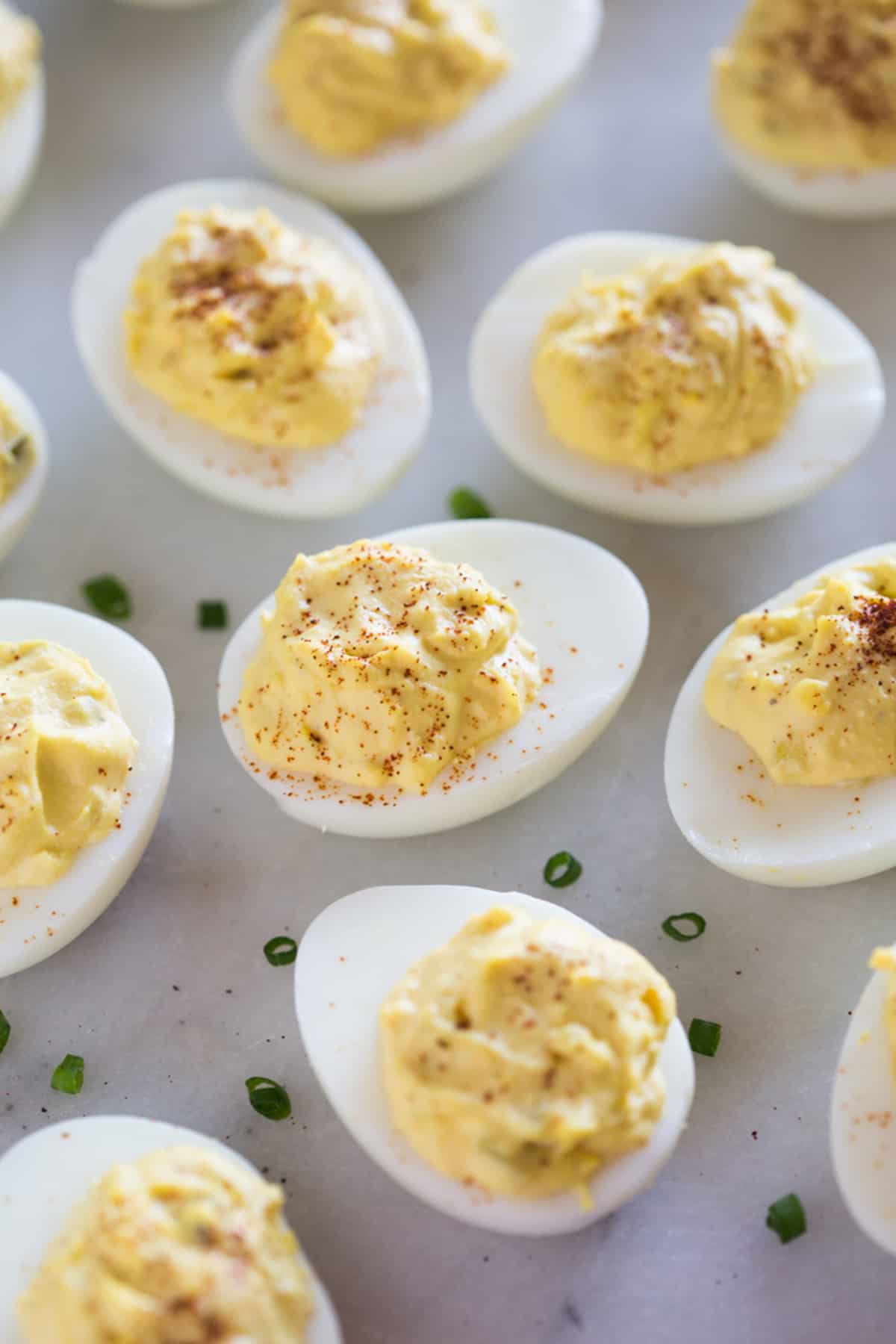 A bunch of Deviled Eggs, sprinkled with paprika and ready to eat.