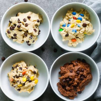 An easy edible cookie dough recipe that is being used to make 4 different cookie dough flavors, each in their own bowl: chocolate chip, peanut butter, m&m, and double chocolate.