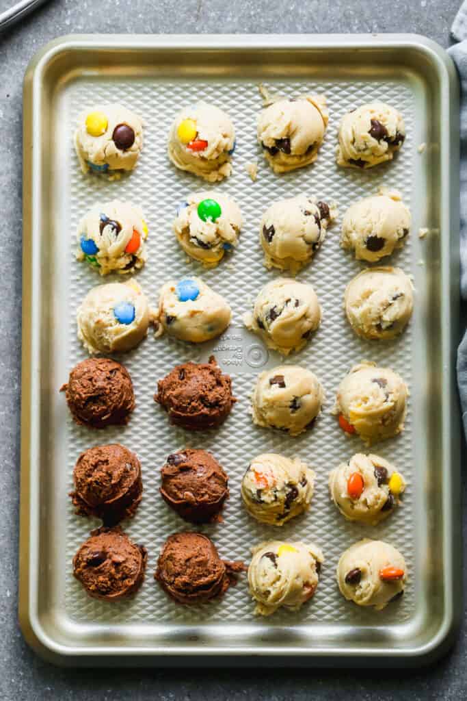 A tray with rolled up balls of edible cookie dough.