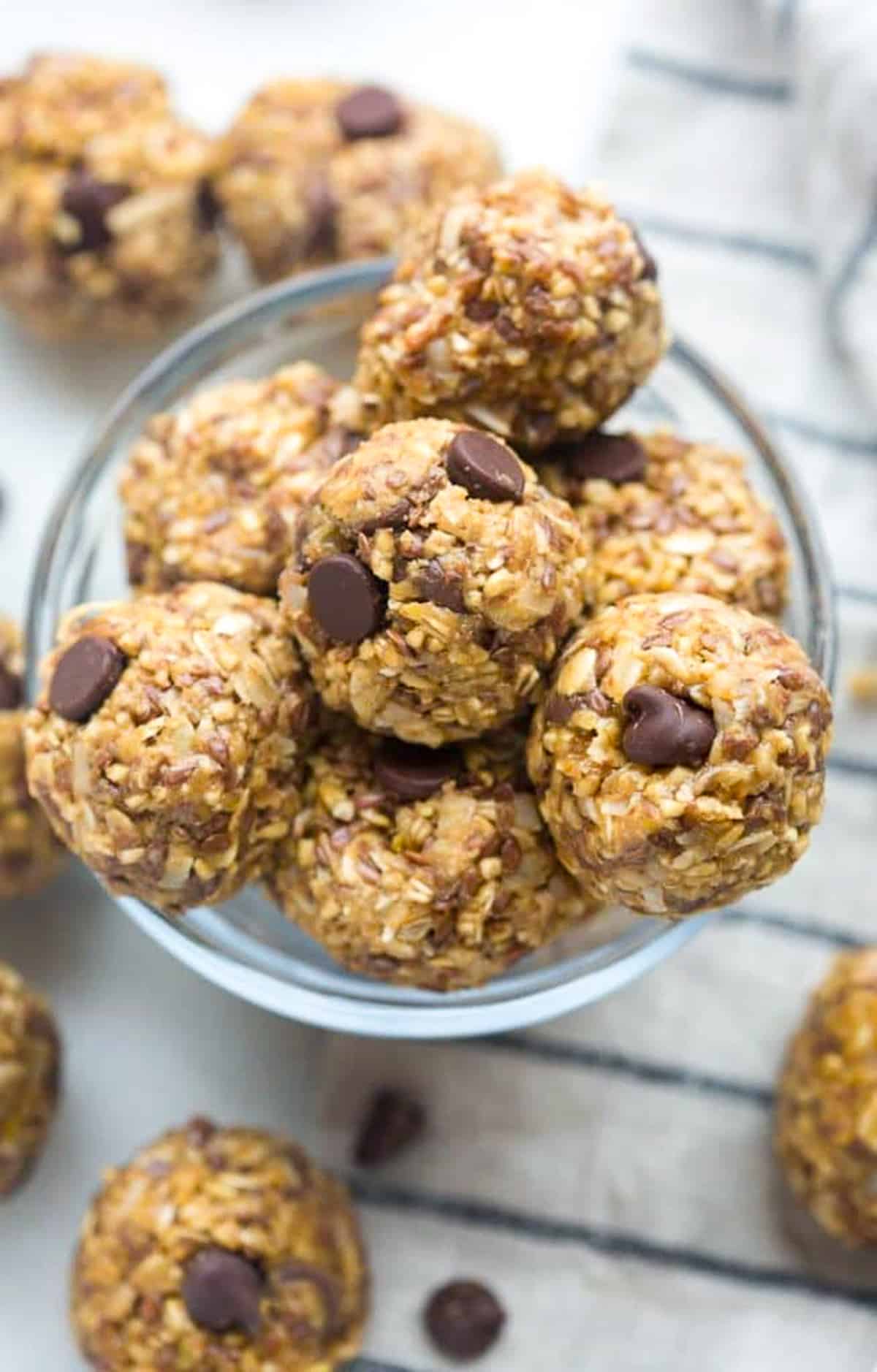 A jar filled with Energy Balls, made with oats, peanut butter, honey, chocolate chips, and coconut.