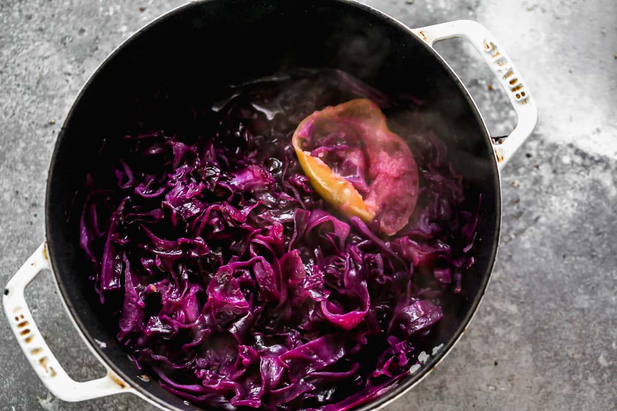 A pot of cooked red cabbage with apple in a pot.