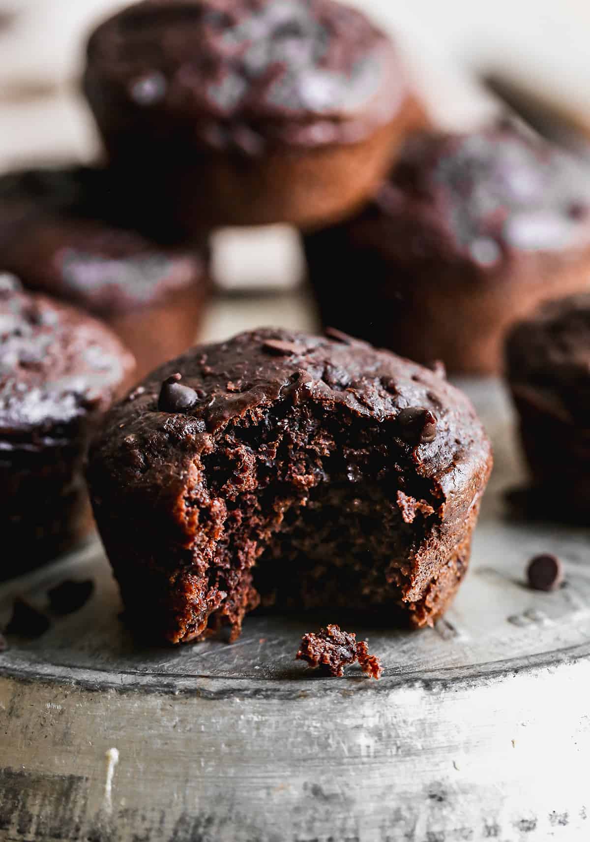 A healthy chocolate muffin with a bite taken out to show how moist and delicious it is.