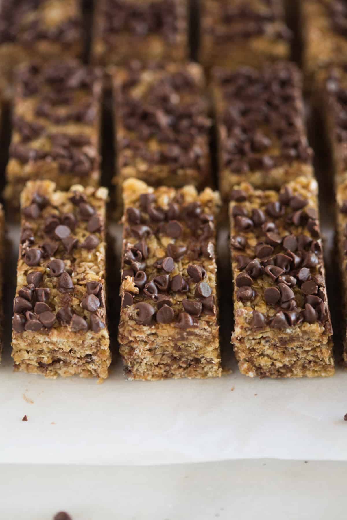 Homemade granola bars topped with mini chocolate chips, cut into bars and ready to eat.