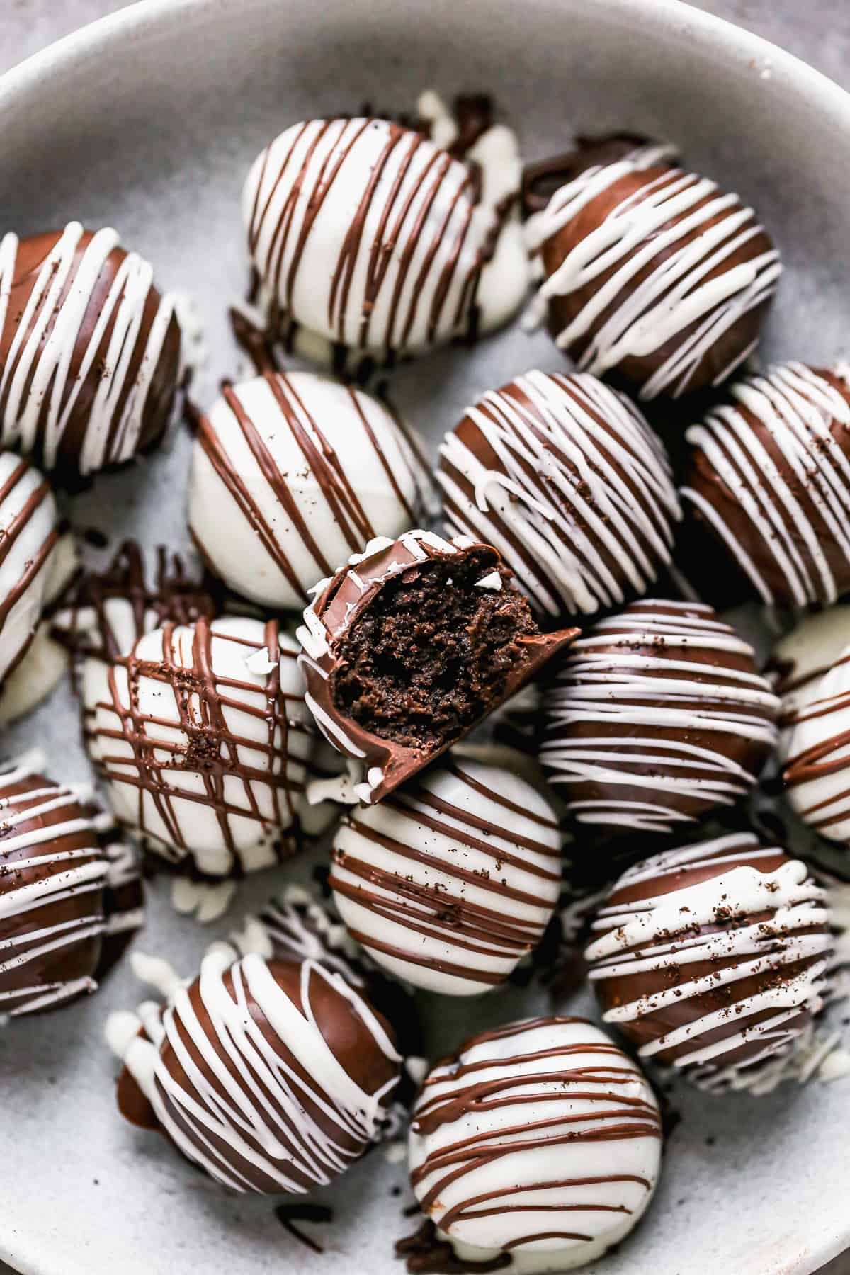 The best Oreo Balls recipe with a bite taken out of one to show the creamy interior. 