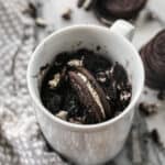 The best Oreo Mug Cake recipe in a white mug, made with just 3 ingredients.