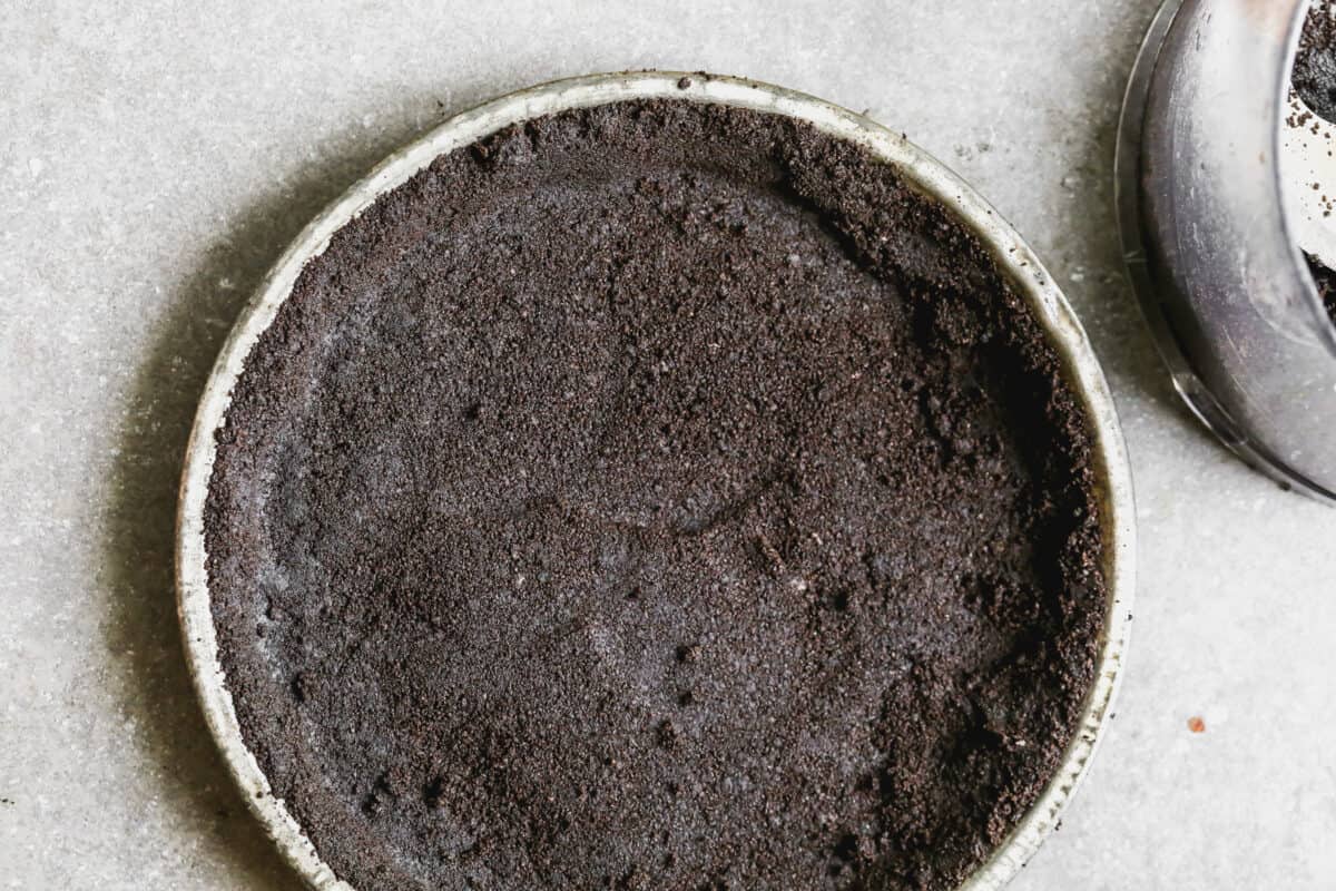 An Oreo crust in a pie plate for a homemade Peanut Butter Pie recipe.