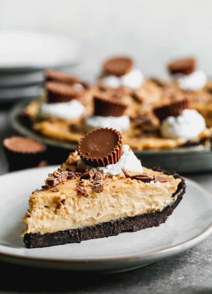 A slice of Peanut Butter Pie on a white plate, ready to enjoy.