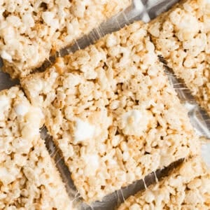 The best rice krispie treats recipe on a piece of parchment paper and cut into squares.