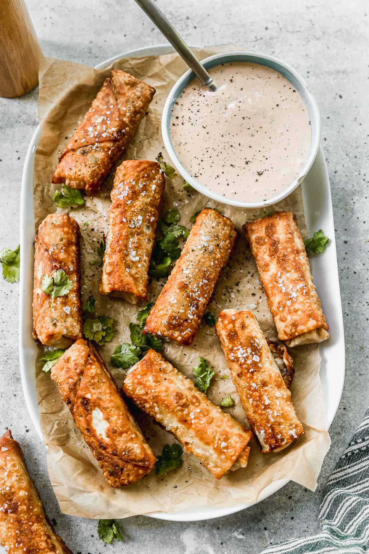 Easy southwest egg rolls on a platter with a homemade dipping sauce, ready to enjoy.