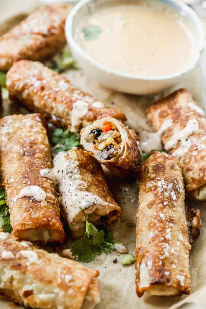 A platter of easy Southwest Egg Rolls, with one of them cut in half.