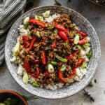 Thai Basil Beef served over white rice in a bowl, ready to eat.